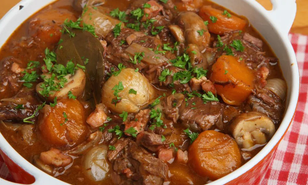 Rich beef stew simmered with carrots, mushrooms, onions and fresh chopped parsley in ceramic casserole pot at Eat Time, a Chinese Restaurant in Burien